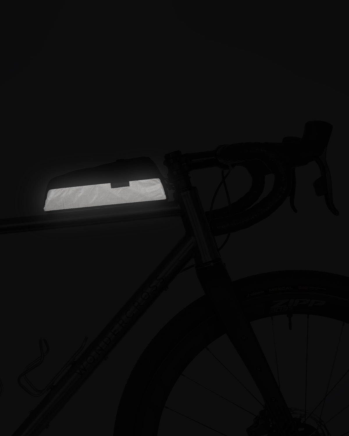 Skingrowsback hot dog racing bolt on top tube bag showing reflective element against a black background