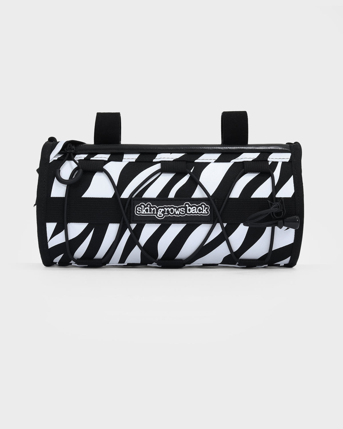 skingrowsback lunchbox handlebar bag black and white zebra print with a white background