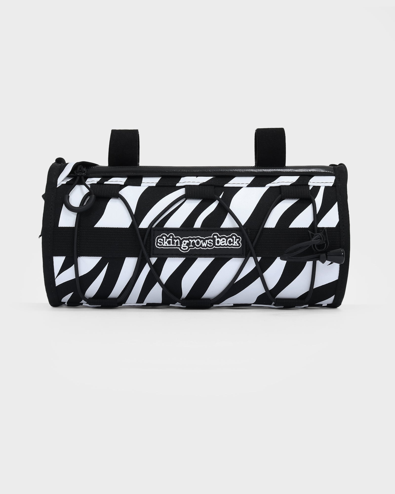 skingrowsback lunchbox handlebar bag black and white zebra print with a white background