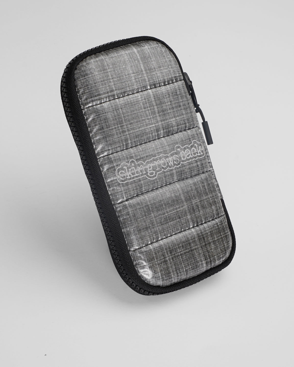 skingrowsback phone jacket with dyneema silver zip case with logo on a grey background