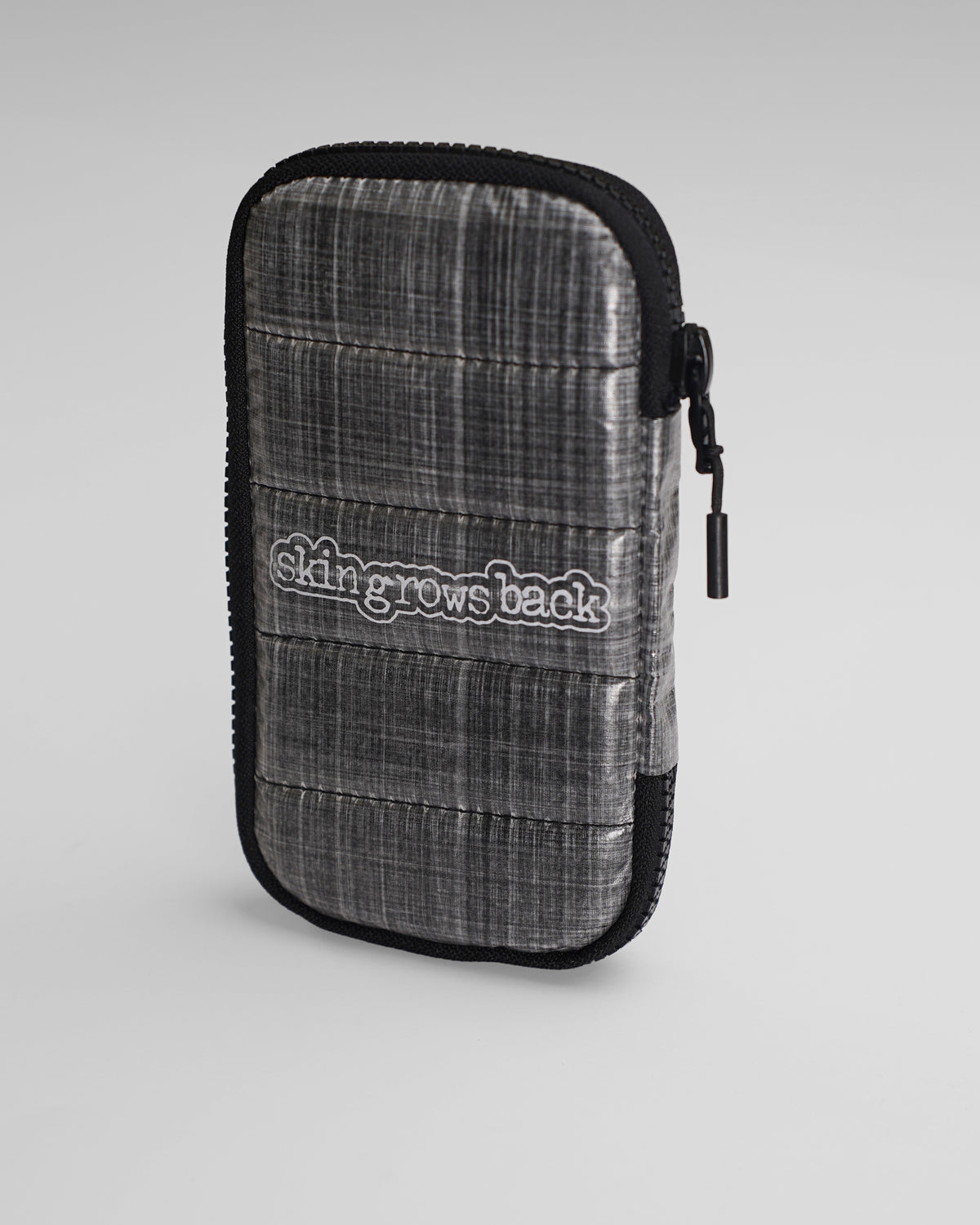 skingrowsback phone jacket with dyneema silver zip case with logo on a grey background