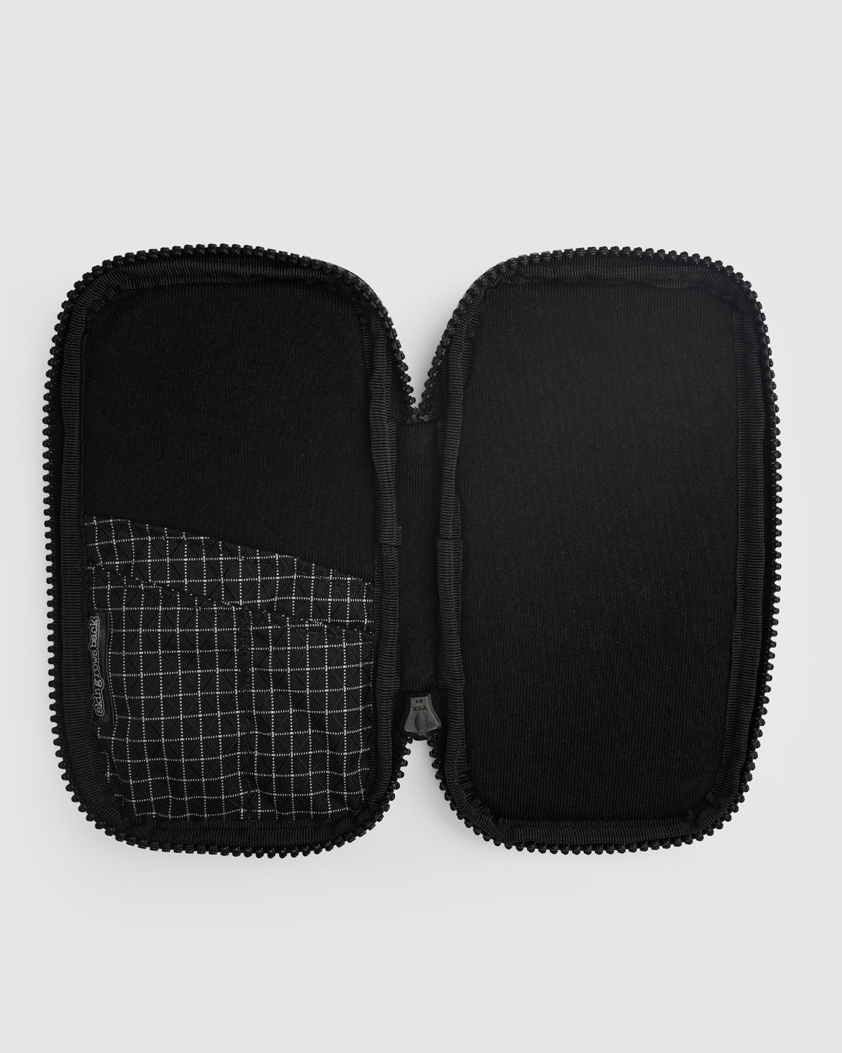 skingrowsback phone jacket with dyneema zip case open black inside panel with squares on a grey background