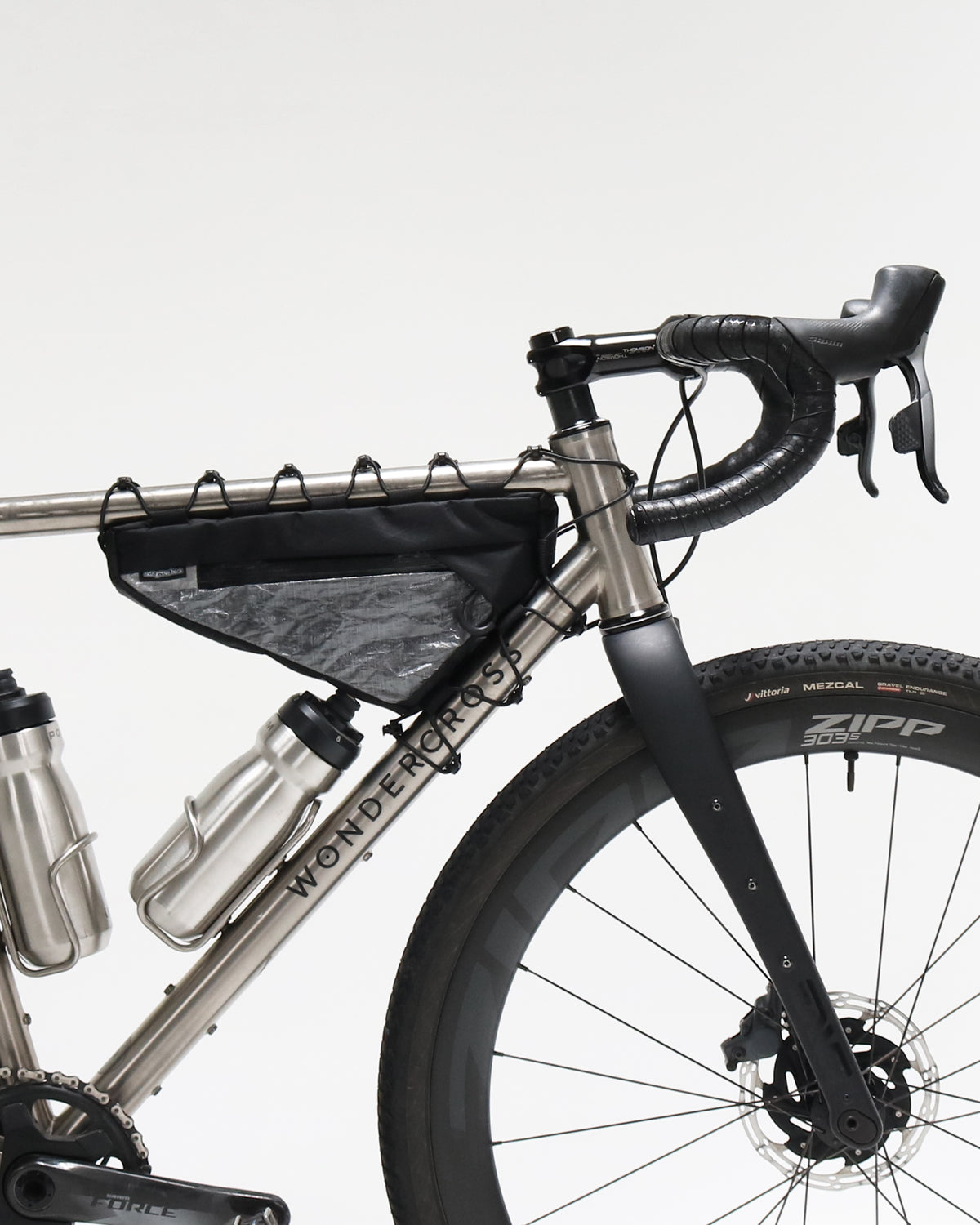 Skingrowsback Wedge Racing frame bag black xpac vx21 silver dyneema on a titanium gravel bike on a white background