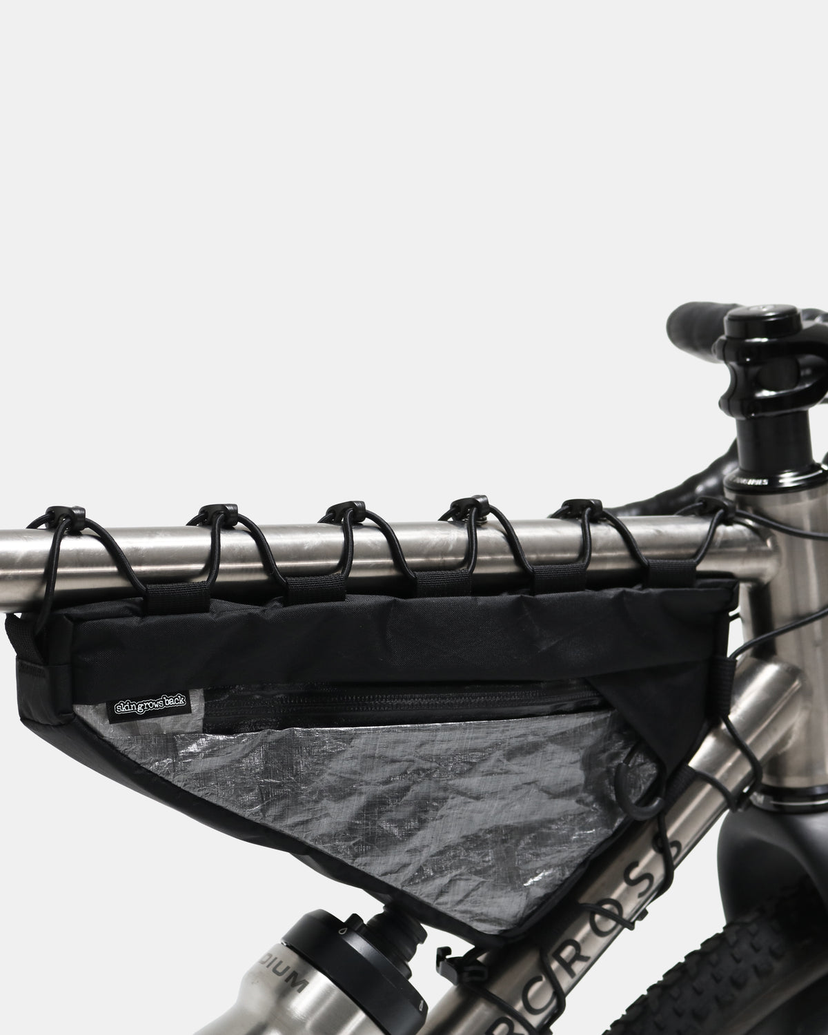 Skingrowsback Wedge Racing frame bag black xpac vx21 silver dyneema on a titanium gravel bike on a white background