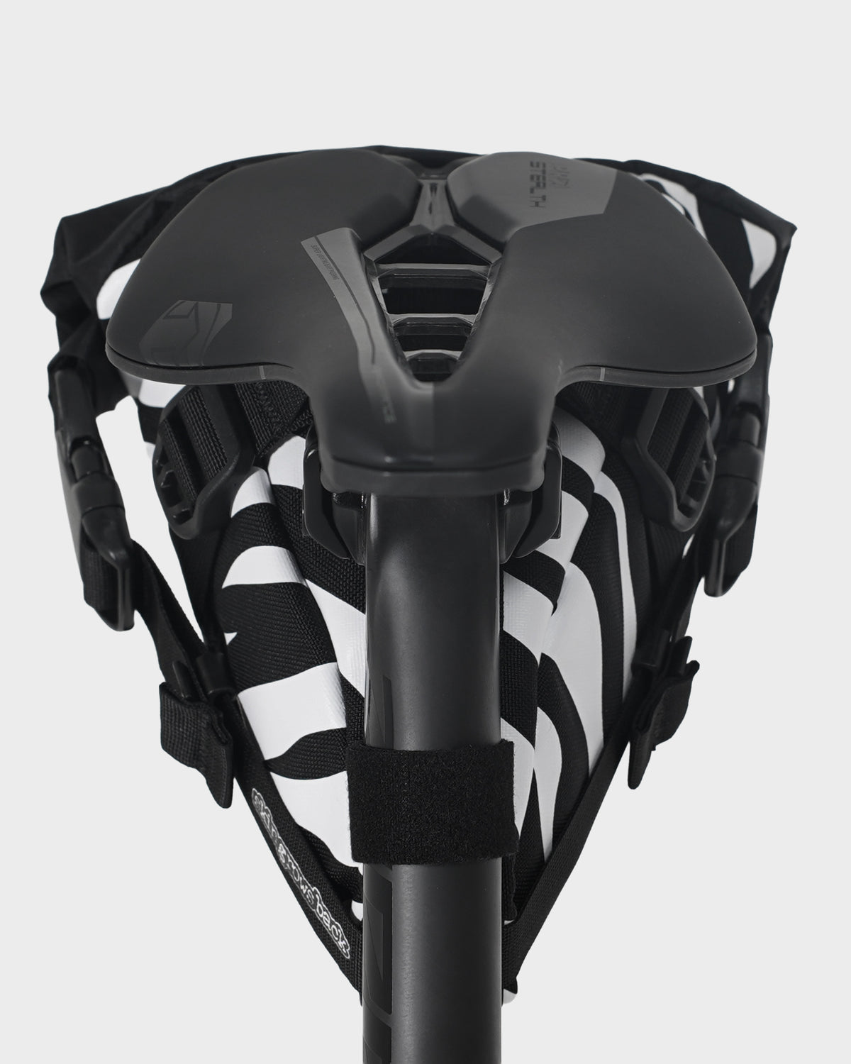skingrowsback flash pak saddle bag black and white zebra print on a black bike saddle with a white background