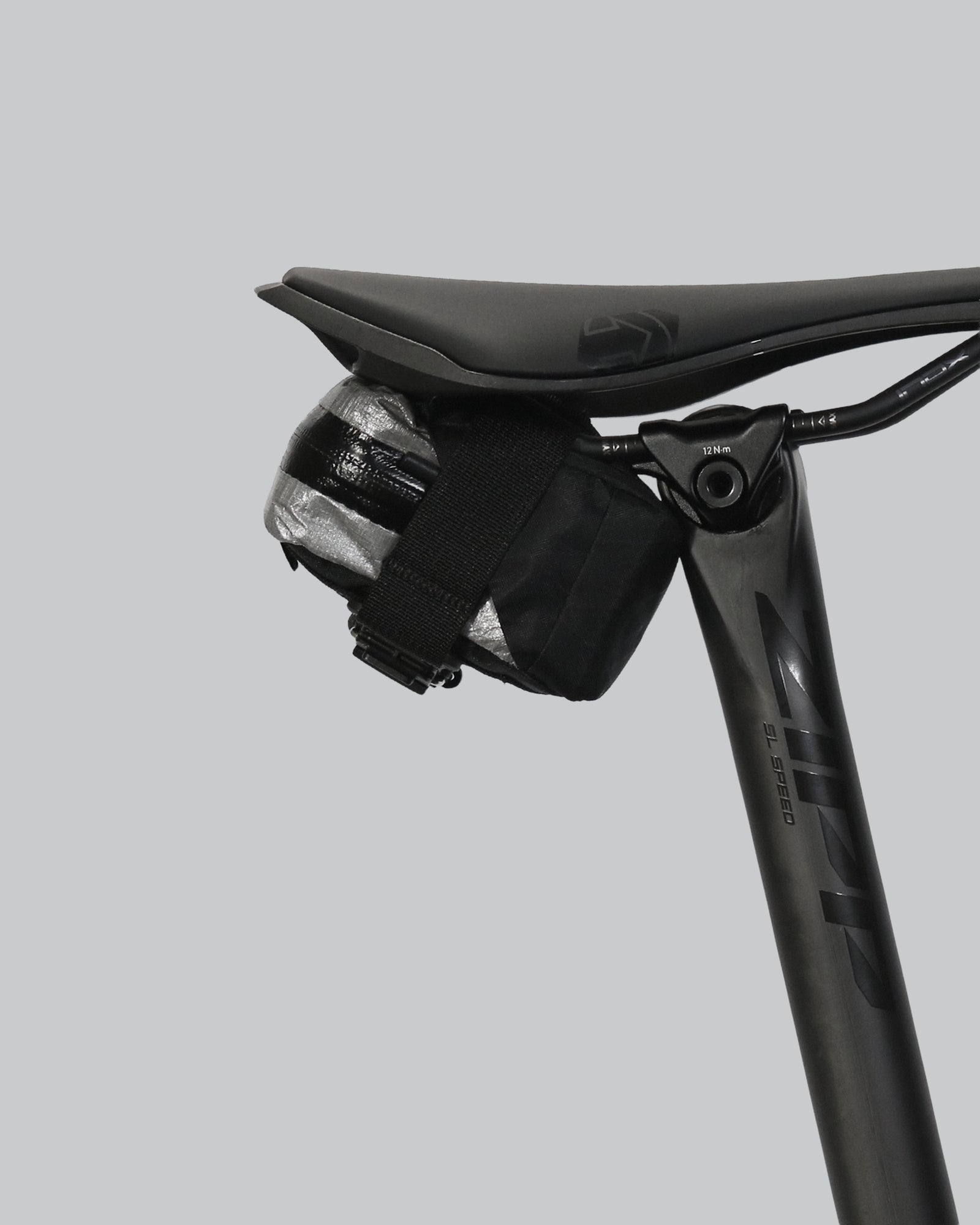 skingrowsback plan b micron racing saddle bag black xpac vx21 plus reflective dyneema on a black bike seat