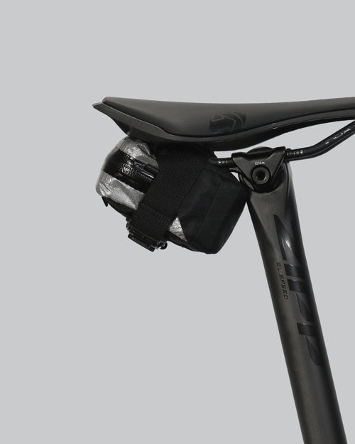 skingrowsback plan b micron racing saddle bag black xpac vx21 plus reflective dyneema on a black bike seat