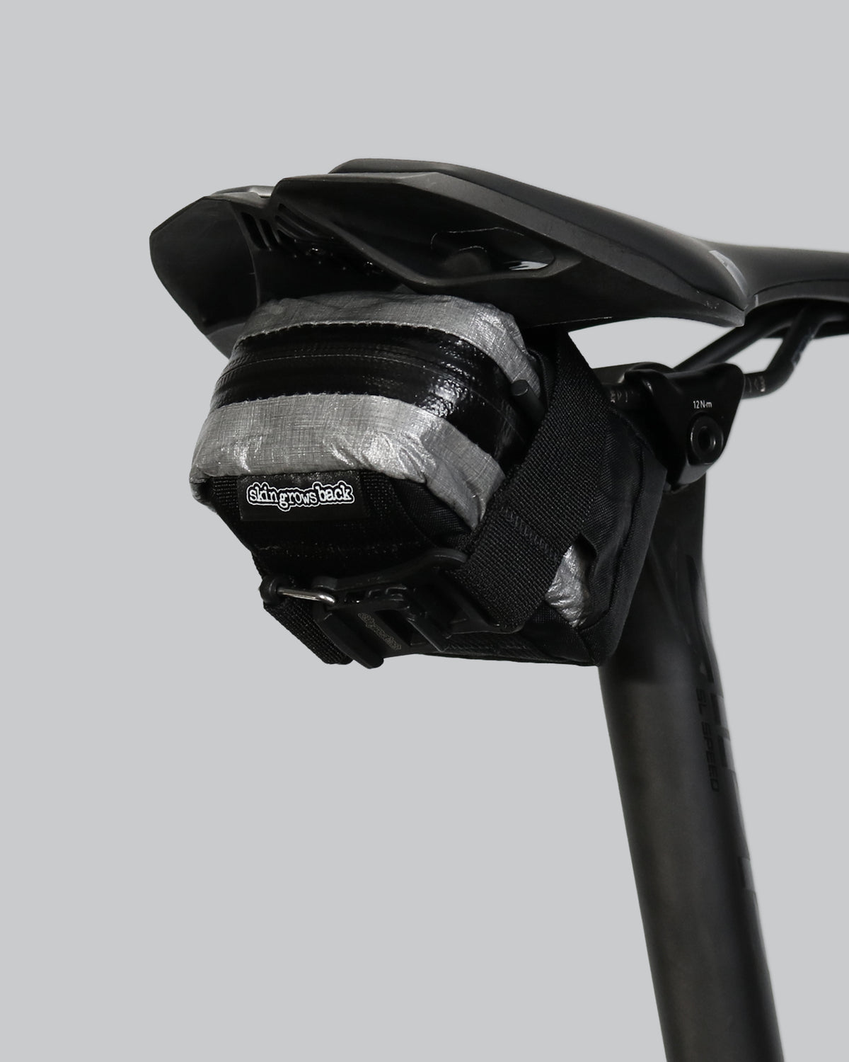 skingrowsback plan b micron racing saddle bag black xpac vx21 plus reflective dyneema on a black bike seat