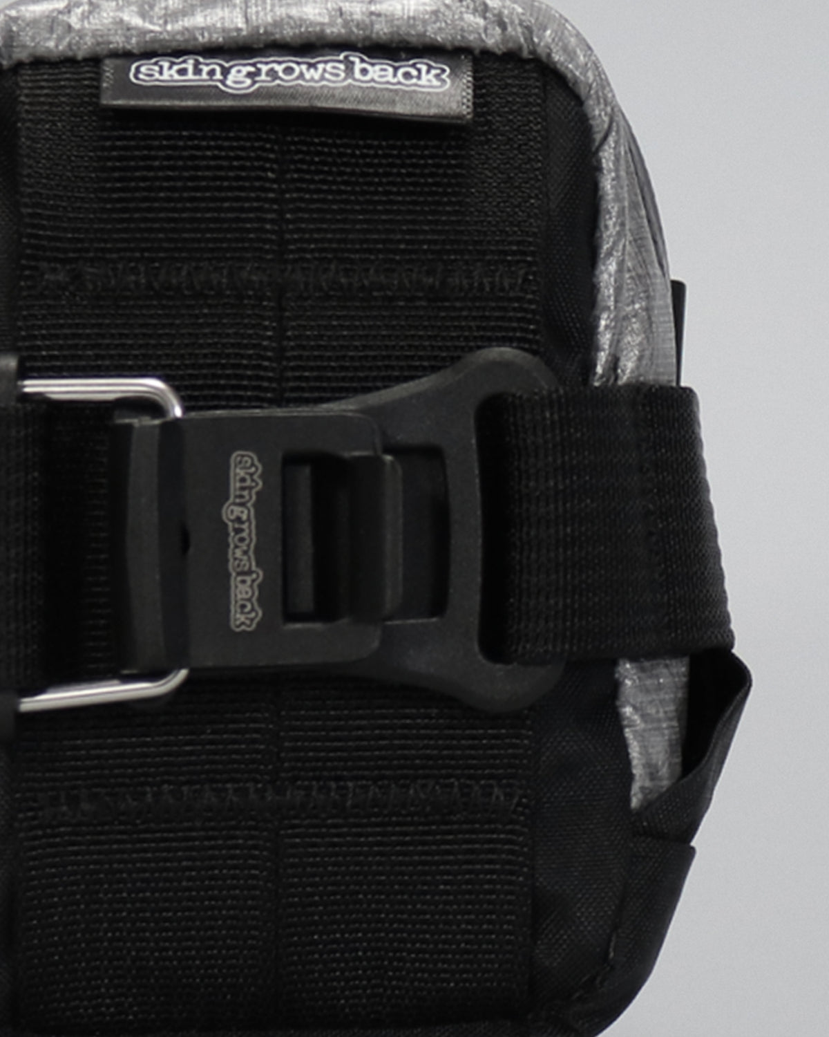skingrowsback plan b micron racing saddle bag black xpac vx21 plus reflective dyneema close up on a grey background