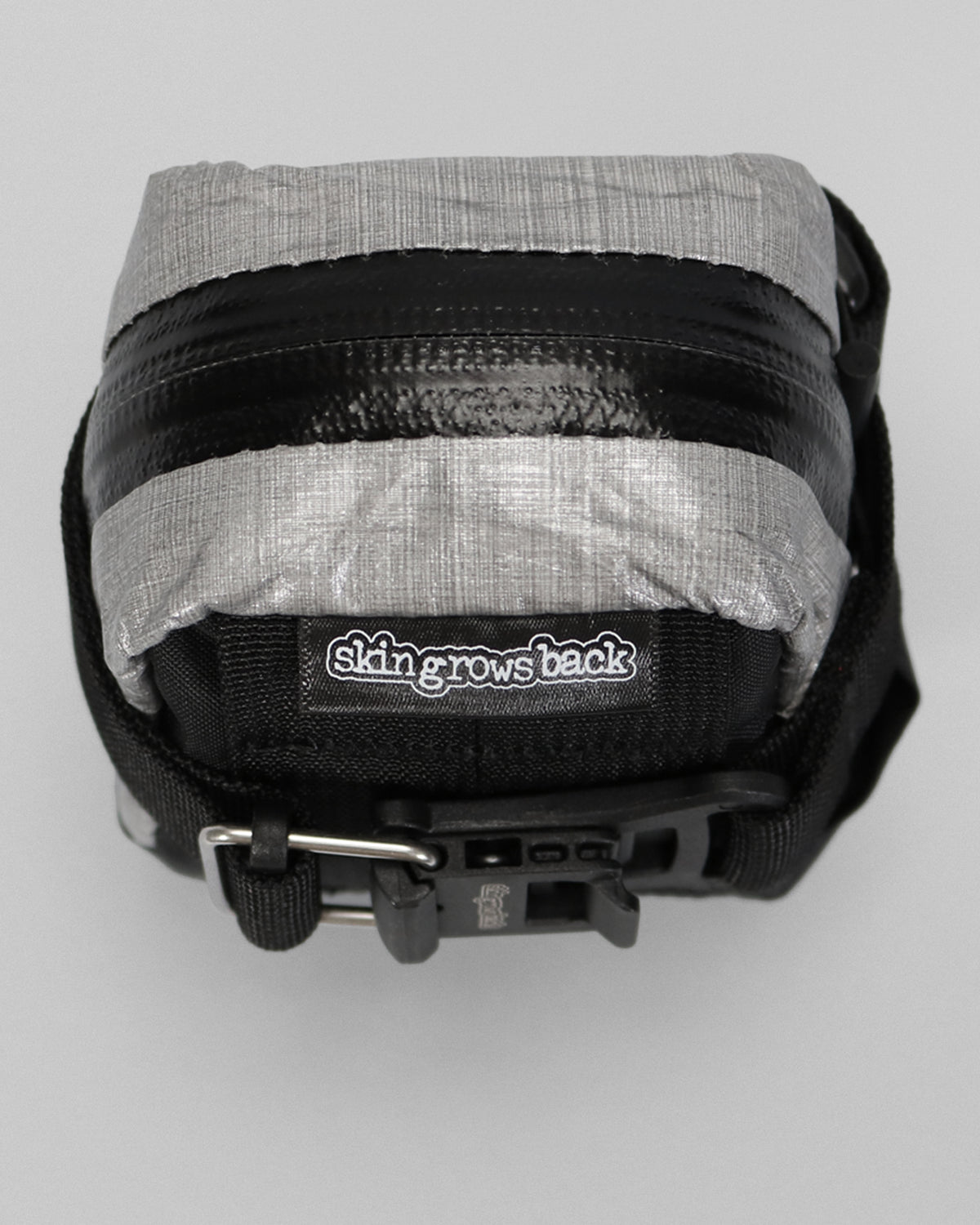skingrowsback plan b micron racing saddle bag black xpac vx21 plus reflective dyneema close up on a grey background