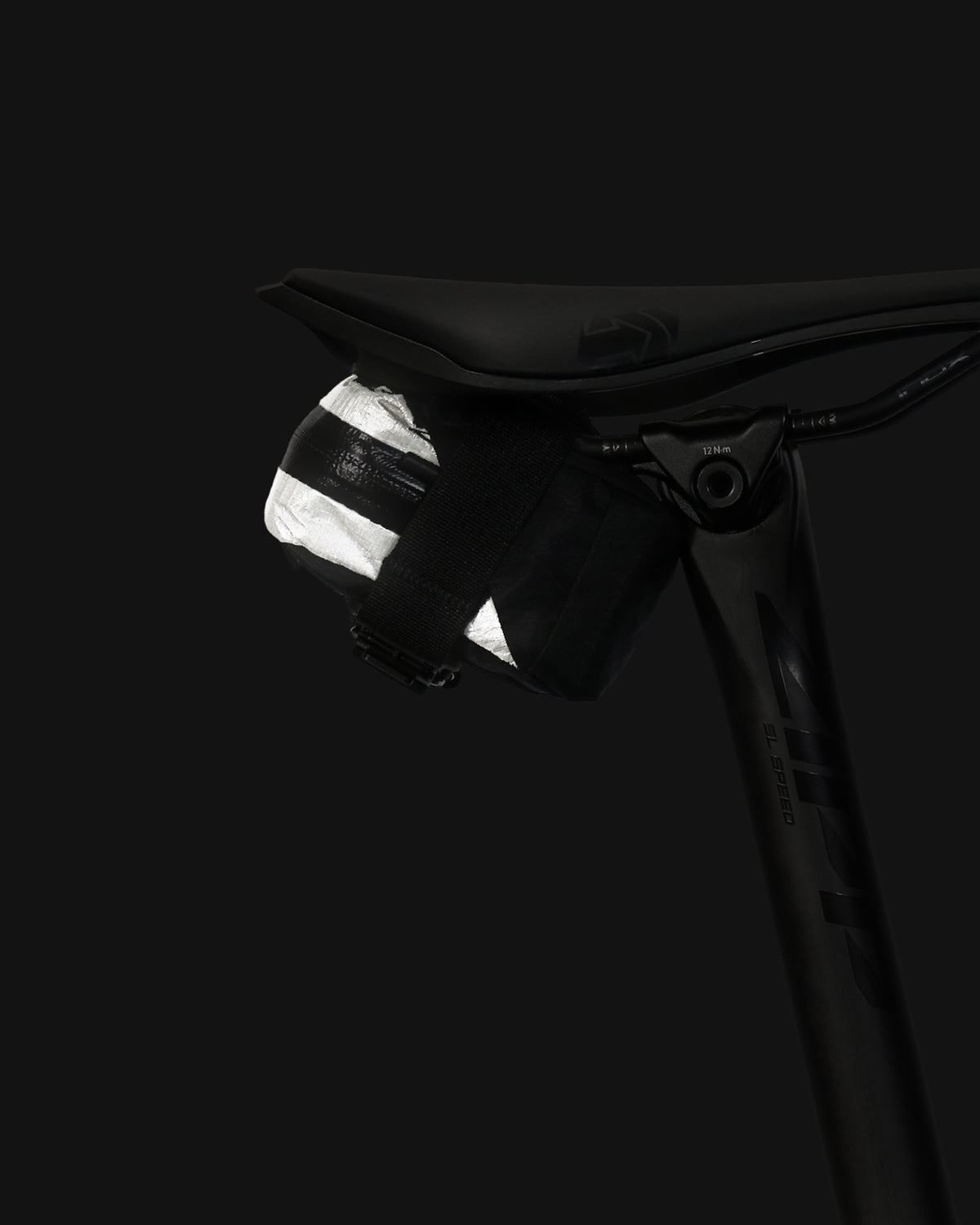 skingrowsback plan b micron racing saddle bag black xpac vx21 plus reflective dyneema close up on a black background
