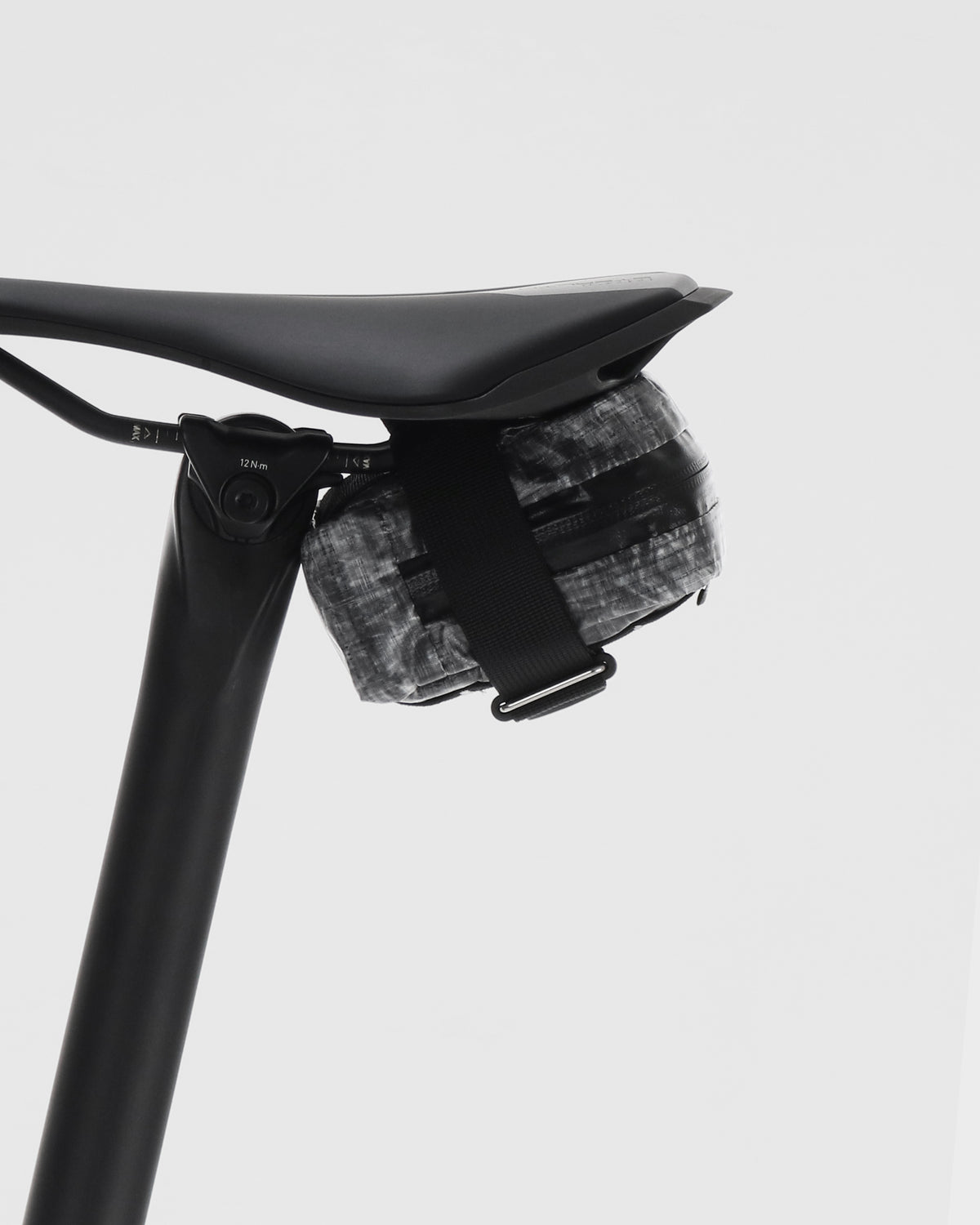 skingrowsback plan b micron saddle bag dyneema black on a black bicycle seat and seatpost against a white background