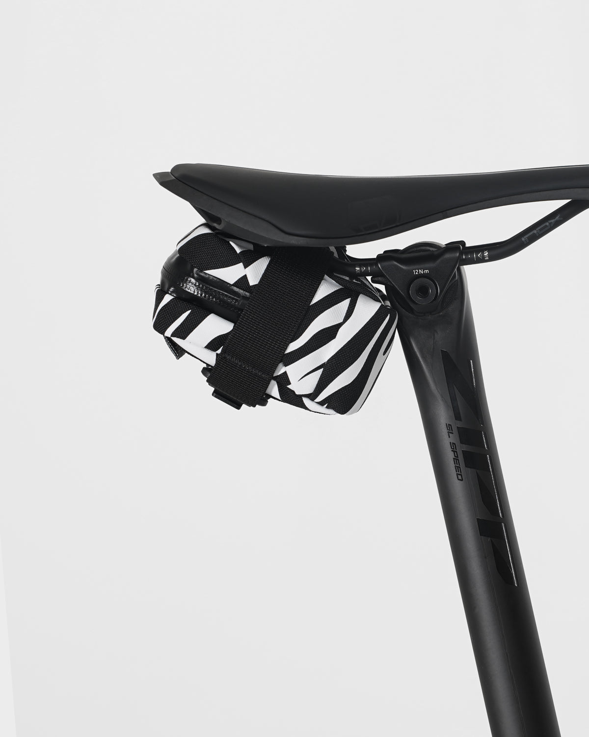 skingrowsback plan b micron saddle bag black and white zebra print on black saddle with a white background