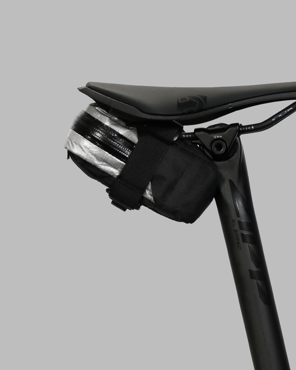 Skingrowsback plan b micron racing saddle bag black xpac vx21 plus reflective dyneema on a black bike seat