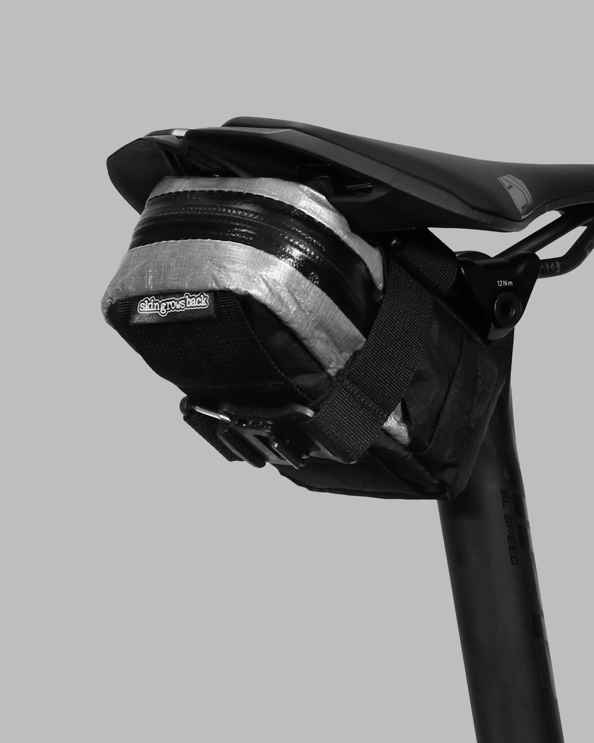 Skingrowsback plan b micron racing saddle bag black xpac vx21 plus reflective dyneema on a black bike seat