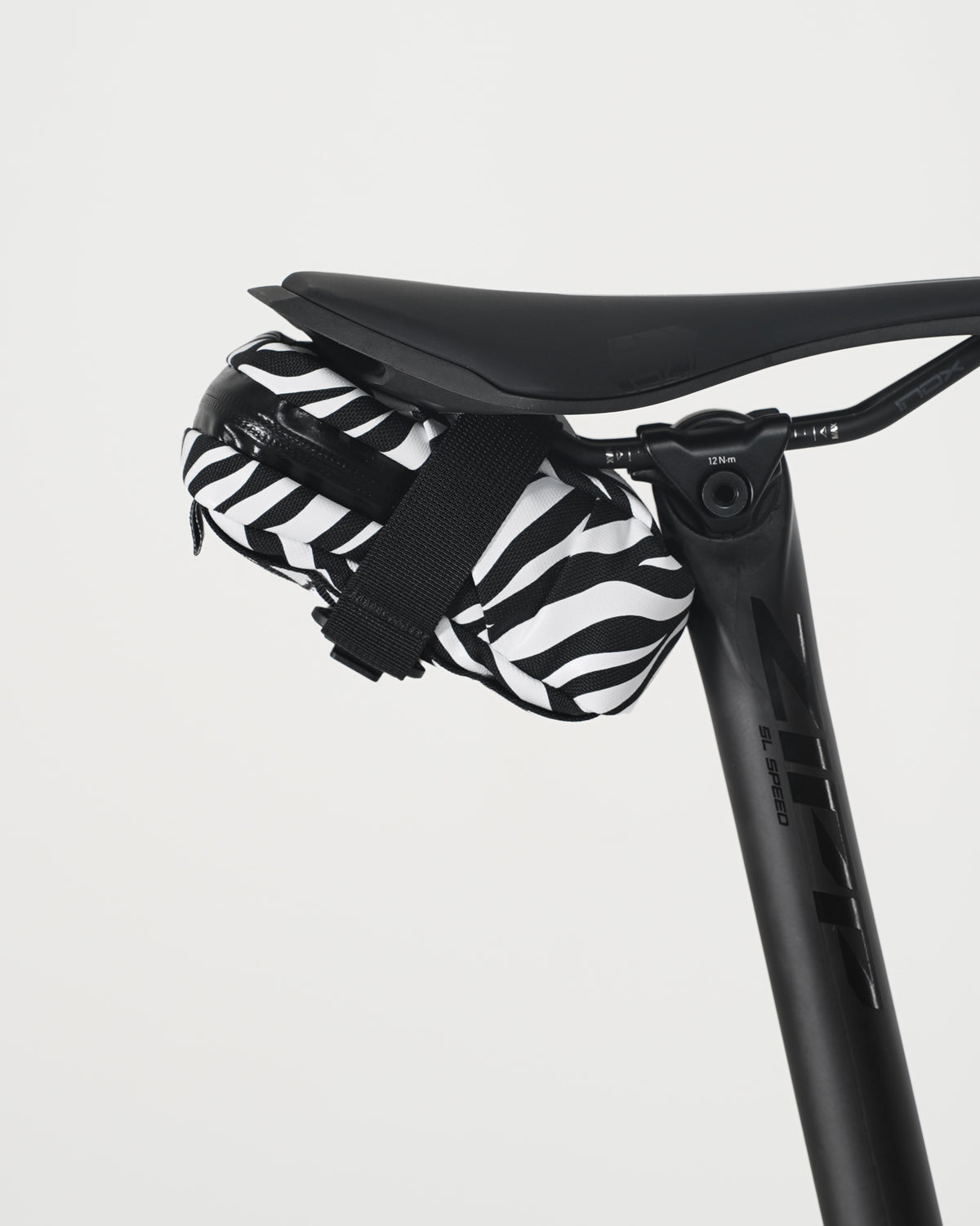 skingrowsback plan b saddle bag black and white zebra print on black saddle with a white background