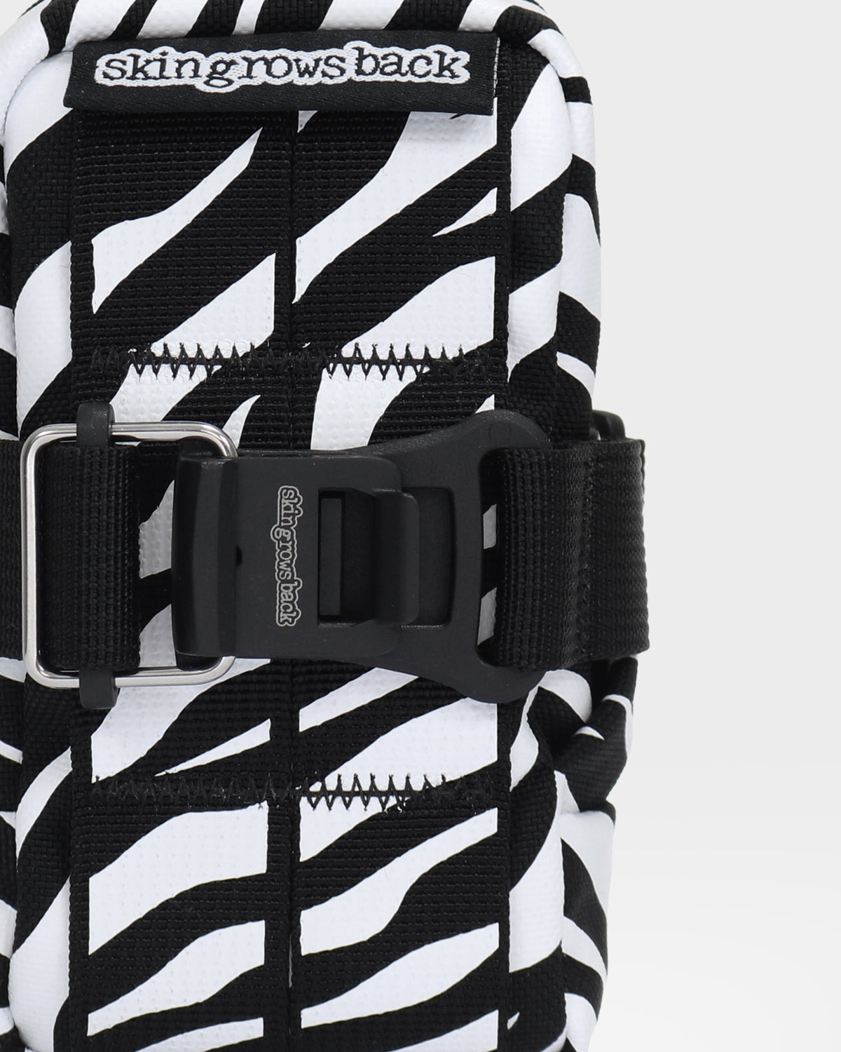 skingrowsback plan b saddle bag black and white zebra print with a white background