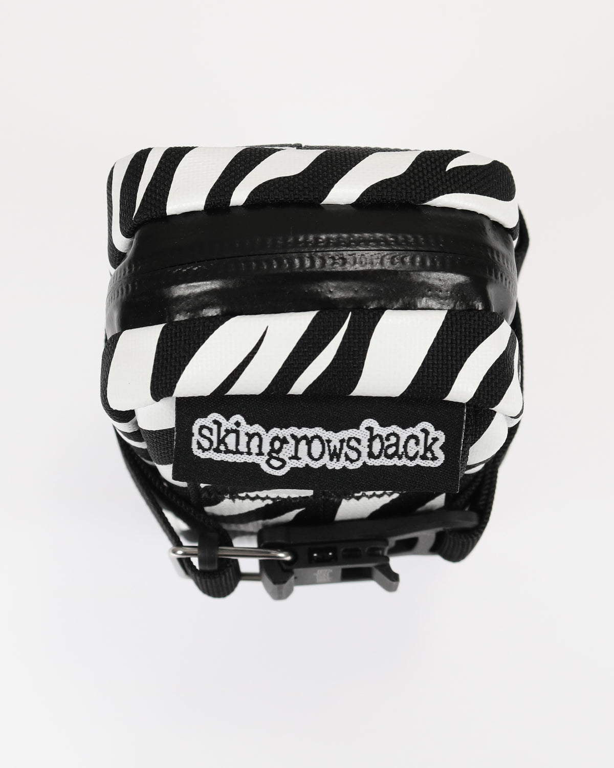 skingrowsback plan b saddle bag black and white zebra print with a white background