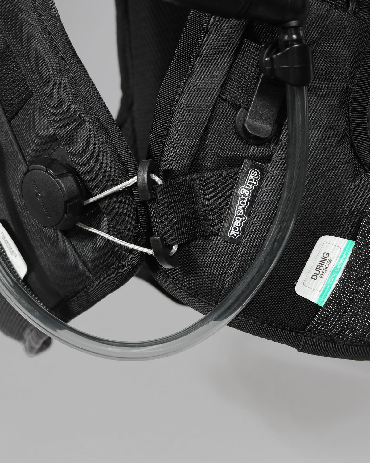 Skingrowsback transcend racing series transition 1.5 litre hydration backpack black and silver against a grey background