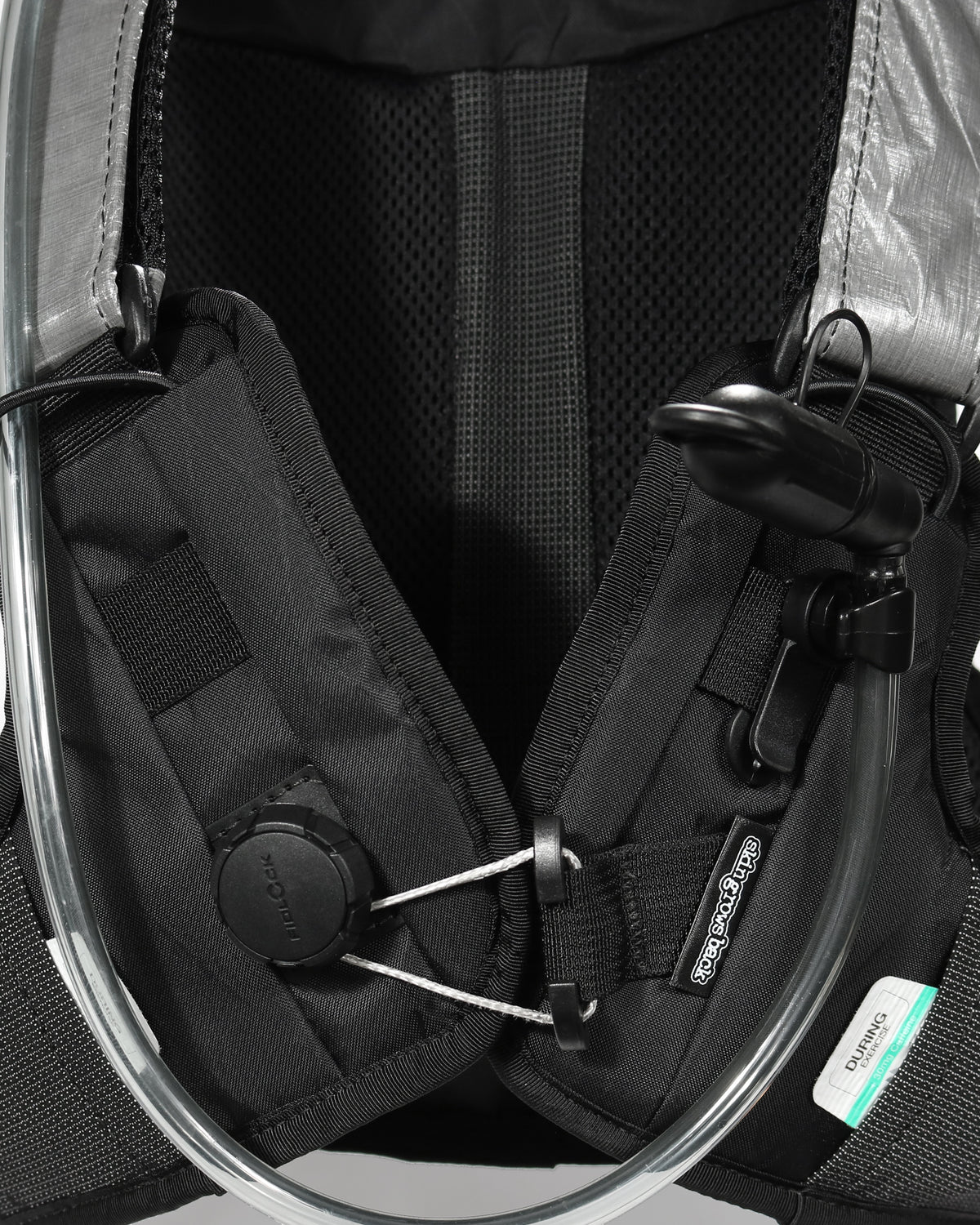 Skingrowsback transcend racing series transition 1.5 litre hydration backpack black and silver against a grey
 background